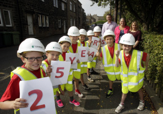 Termrim Construction’s Managing Director Graeme Bird with Netherthong Primary School pupils ahead of the Netherthong 10K.